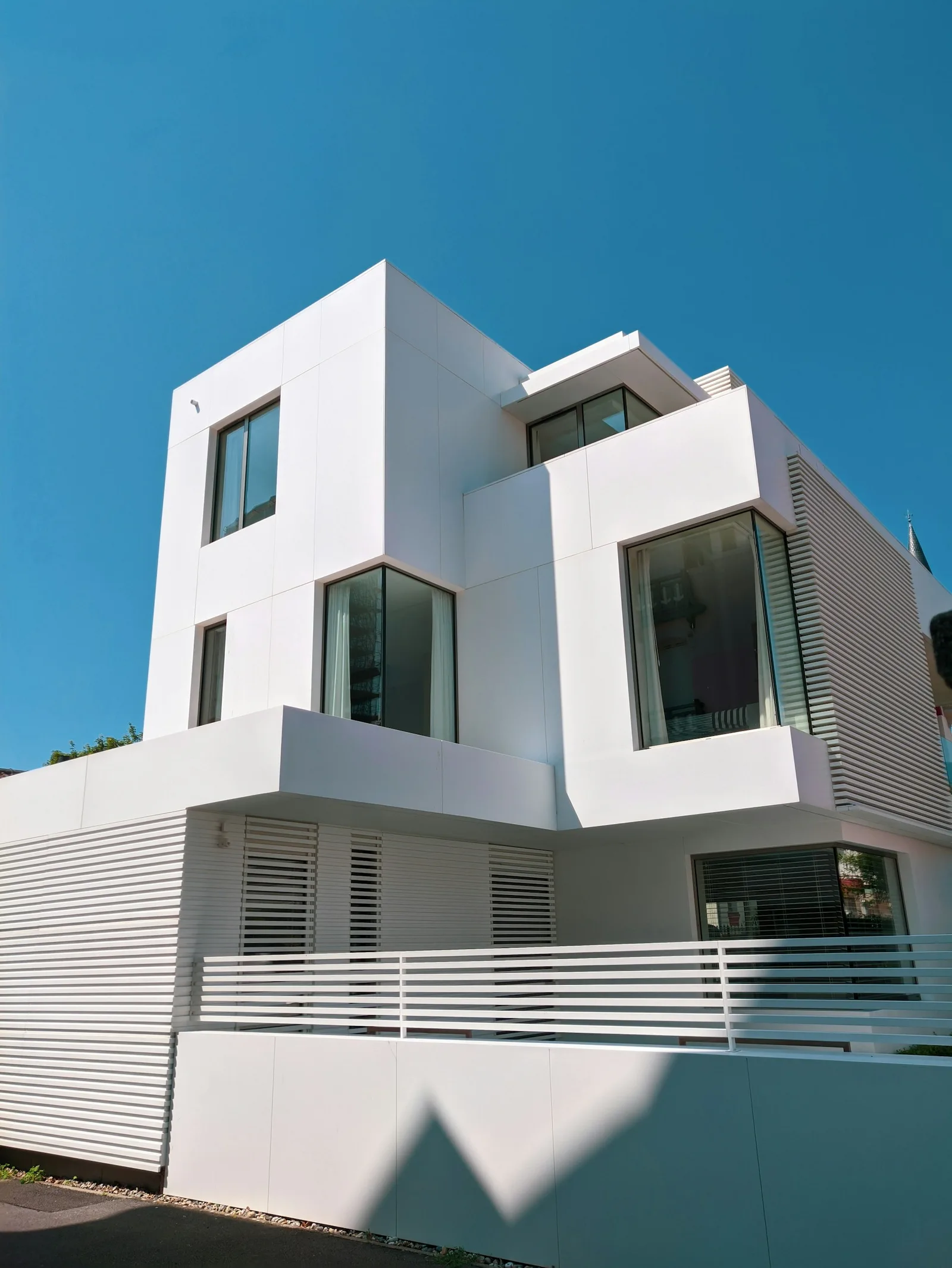 Contemporary home with a smooth white facade