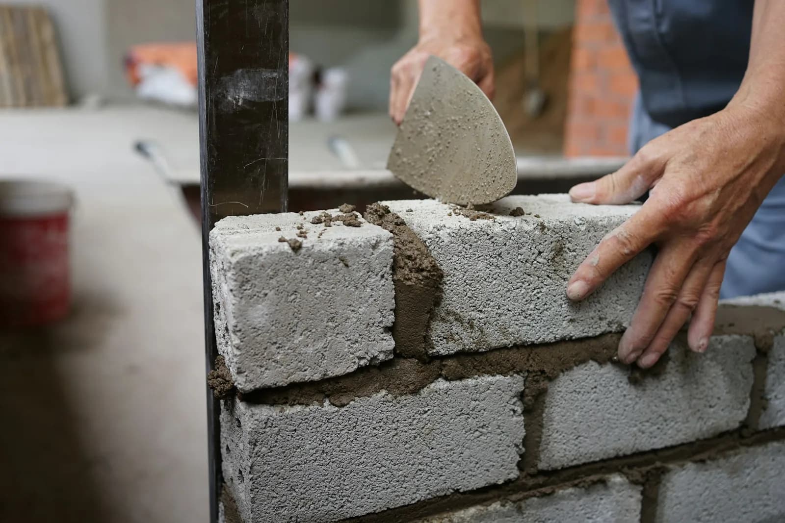 Tradesperson installing lightweight wall blocks