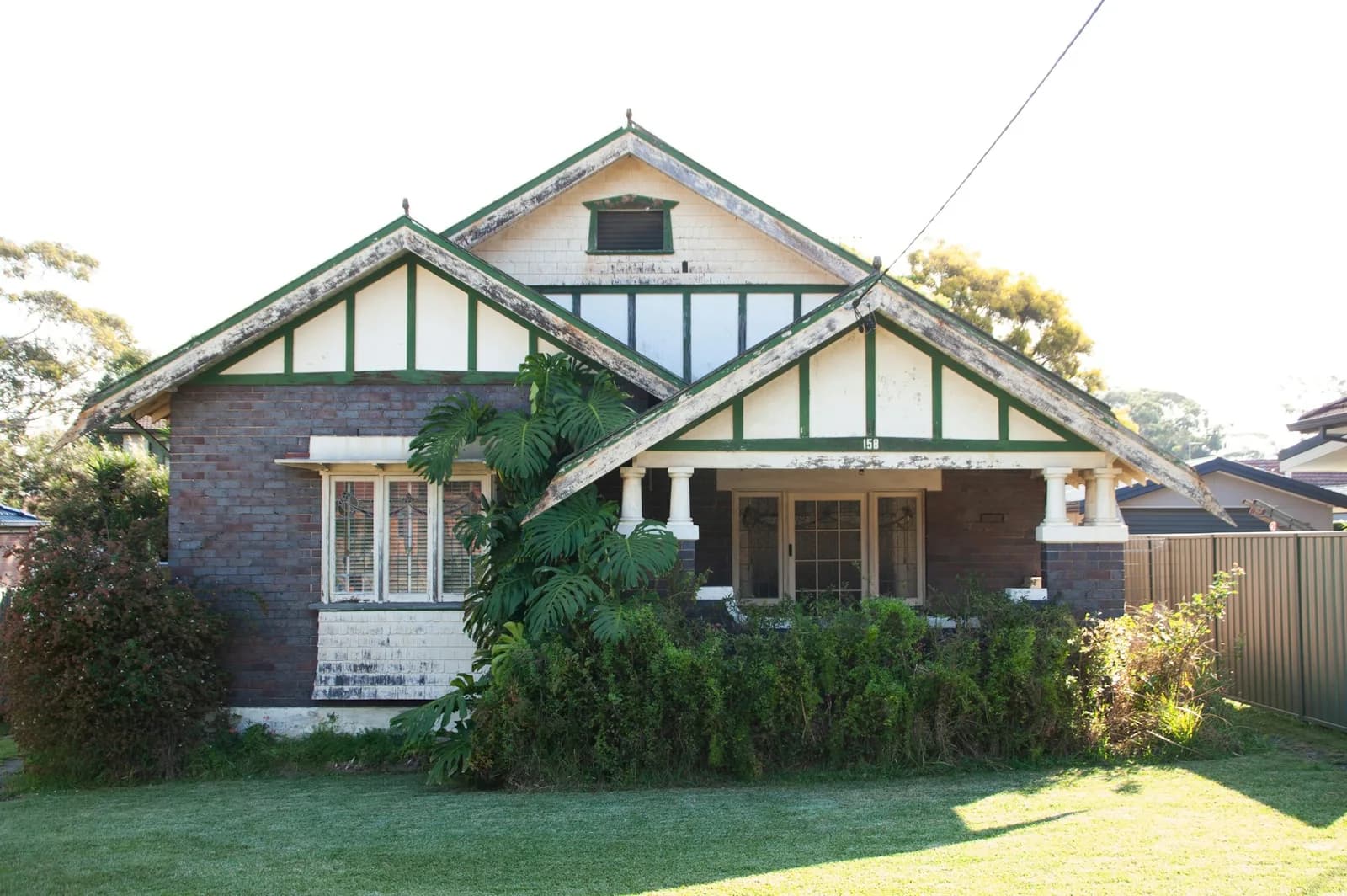 Brick bungalow with a front garden in a leafy suburb